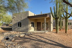 A single-story building with a patio area, a door, and windows. - Saguaro Grove, Built May '26, Smart Lock, Quiet Cul-de-sac (Tucson)