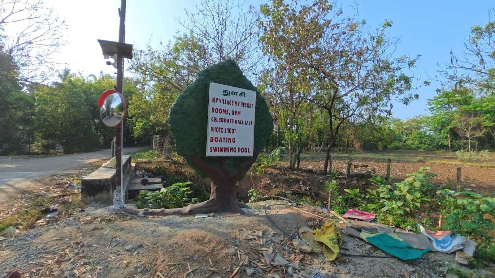 A signboard with amenities listed: rooms, gym, celebrate hall, photo shoot, boating, swimming pool.