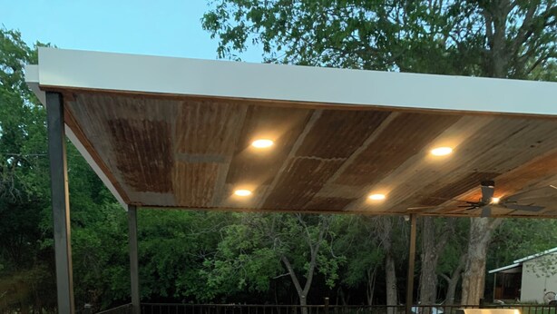 An outdoor patio with a covered seating area, a grill, and a paved floor. - Firefly Cabin, Lake Whitney , Pool & Hot Tub, Boat Parking Fire Pit, Grills. (Clifton)