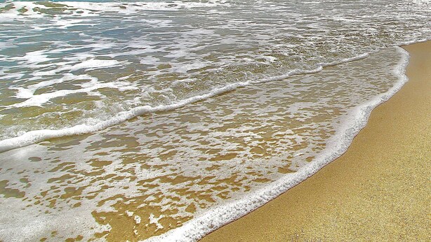 A beach with waves gently lapping onto the shore. - Blue Pelican Stay - New listing with Hot Tub and Heated Pool (Port St. Lucie)