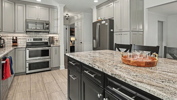 A kitchen with white cabinets, stainless steel appliances, a granite countertop, and a wooden serving tray. - Modern Oasis-Pool, Hot-tub, Bar near Saratoga (Ballston Spa)