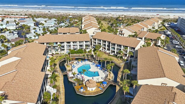 A resort with a central pool, a beach view, and a marina. - The Turtle Nest Coastal Escape (St. Augustine)