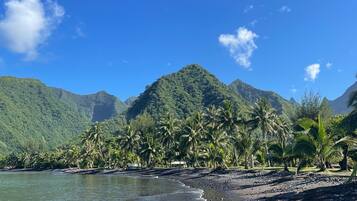On the beach, black sand