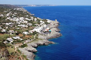 A coastal town with white buildings, a rocky shoreline, and a clear blue sea. - Leuca Relax & Sea n.5C, Castrignano del Capo, Italy (Castrignano del Capo)