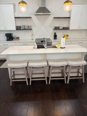 A modern kitchen with a central island, bar stools, stainless steel appliances, and pendant lighting. - 4 Bedroom Beauty in Vestavia, Minutes to 459, 65 (Mountain Brook)