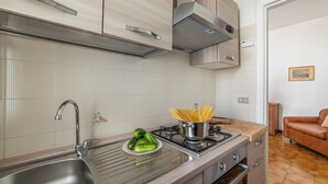 A modern kitchen with a stainless steel sink, a gas stove, and a built-in oven. - Leuca Relax&Sea n.3C, Castrignano del Capo, Italy (Castrignano del Capo)