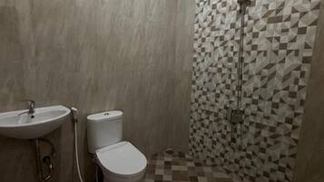 A bathroom with a sink, toilet, and shower.