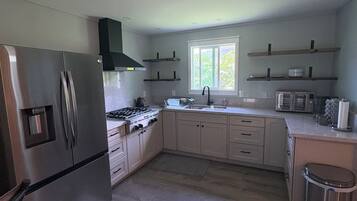 Fridge, coffee/tea maker, cookware/dishes/utensils, paper towels