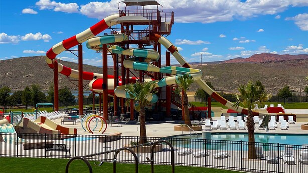 A water park with a large water slide, a pool, and lounge chairs. - Paradise Village Modern Retreat w/ Hot Tub & Pool (Santa Clara)