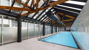 An indoor swimming pool with a high ceiling, large windows, and a tiled floor. - Evi-3B2B Free Parking! Walk to Casino! Sleeps 8! (Southbank)