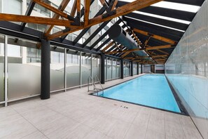 An indoor swimming pool with a high ceiling, large windows, and a tiled floor. - Evi-3B2B Free Parking! Walk to Casino! Sleeps 8! (Southbank)