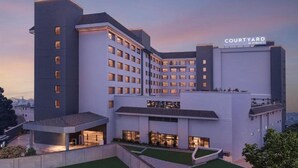A multi-story hotel with a courtyard, modern architecture, and a sign indicating it's a Marriott property. - Courtyard Shillong (Shillong)