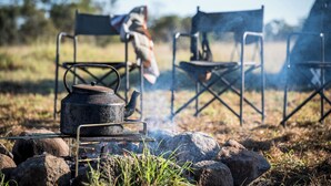 A portable stove with a pot on it, surrounded by rocks and grass. - Letaba Trails Camp- Greater Kruger (Phalaborwa)