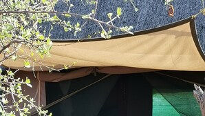 A tent with a bed, two chairs, and a table. - Letaba Trails Camp- Greater Kruger (Phalaborwa)