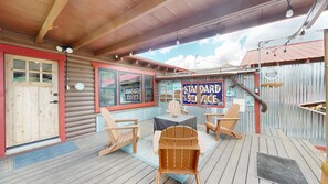 A wooden deck with Adirondack chairs, a table, and a sign reading 'STANDARD ICE CREAM'. - Salmon Trout Retreat - Pitkin (Pitkin)