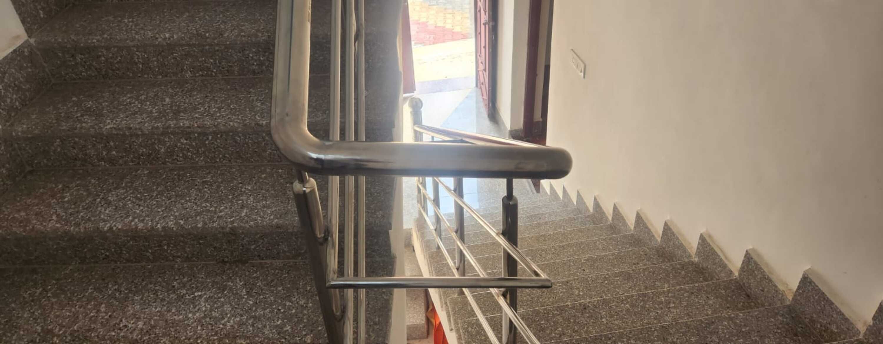 A staircase with metal handrails and a metal banister.