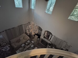 A high-ceilinged room with a chandelier, a fireplace, and a sofa. - Cozy, with unique European settings close to strip (Las Vegas)