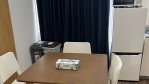 A small kitchenette with a microwave, refrigerator, and a coffee maker on the counter. - GORO HOTEL (Tokyo)
