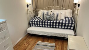 A bedroom with a bed, bedside tables, a dresser, and a rug. - 2-bedroom house in tranquil Grapeview perfect for relaxing getaways (Grapeview)