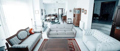 A living room with a sofa, armchair, and a coffee table.