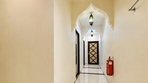 A corridor with a tiled floor, a fire extinguisher, and a door with a geometric pattern. - Palette - Near Amanjaya Mall Formerly El-Zahraa (Sungai Petani)