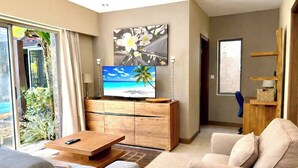 A modern living room with a flat-screen TV, a wooden coffee table, and a sofa. - Tropical Villa Athena Residence (Grand-Baie)