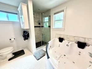 Une salle de bain moderne équipée de toilettes, d’une douche et d’une baignoire.