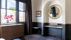 A room with a window, a dresser, a small table, a mirror, and a framed picture on the wall. - Imperial Hotel Paddington (Paddington)