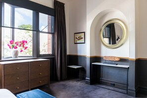 A room with a window, a dresser, a small table, a mirror, and a framed picture on the wall. - Imperial Hotel Paddington (Paddington)