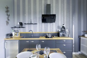 A modern kitchen with a built-in dishwasher, a microwave, and a toaster. - Coeur de Falaise 2 - 2-bedroom apartment downtown, private parking, EV charging station (Falaise)