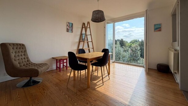 A modern living room with a dining area, a large window with a view, and a ladder leaning against the wall. - Les Toits de Bayonne - Mountain view (BAYONNE)