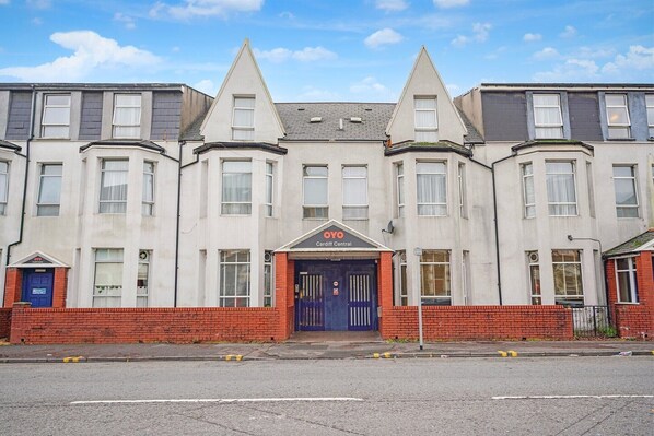 A row of residential buildings with a central entrance marked 'Cardiff Central.' - Standard Triple Room (Cardiff)