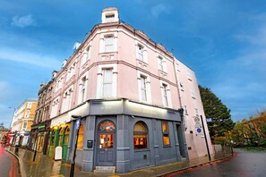 A corner building with a sign reading 'Church Street Hotel.' - Standard Single Room - Shared (London)