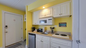 A compact kitchen with white cabinets, a microwave, a toaster, and a dishwasher. - Walk to Boardwalk & Beach! Ocean City Studio (Ocean City)