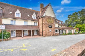 A traditional brick building with a sign reading 'The Thames Lodge.' It features a prominent gabled roof, a brick facade, and a small porch area. - Sunday London Staines-upon-Thames Heathrow T8 - Standard Family of 3 Room (London)