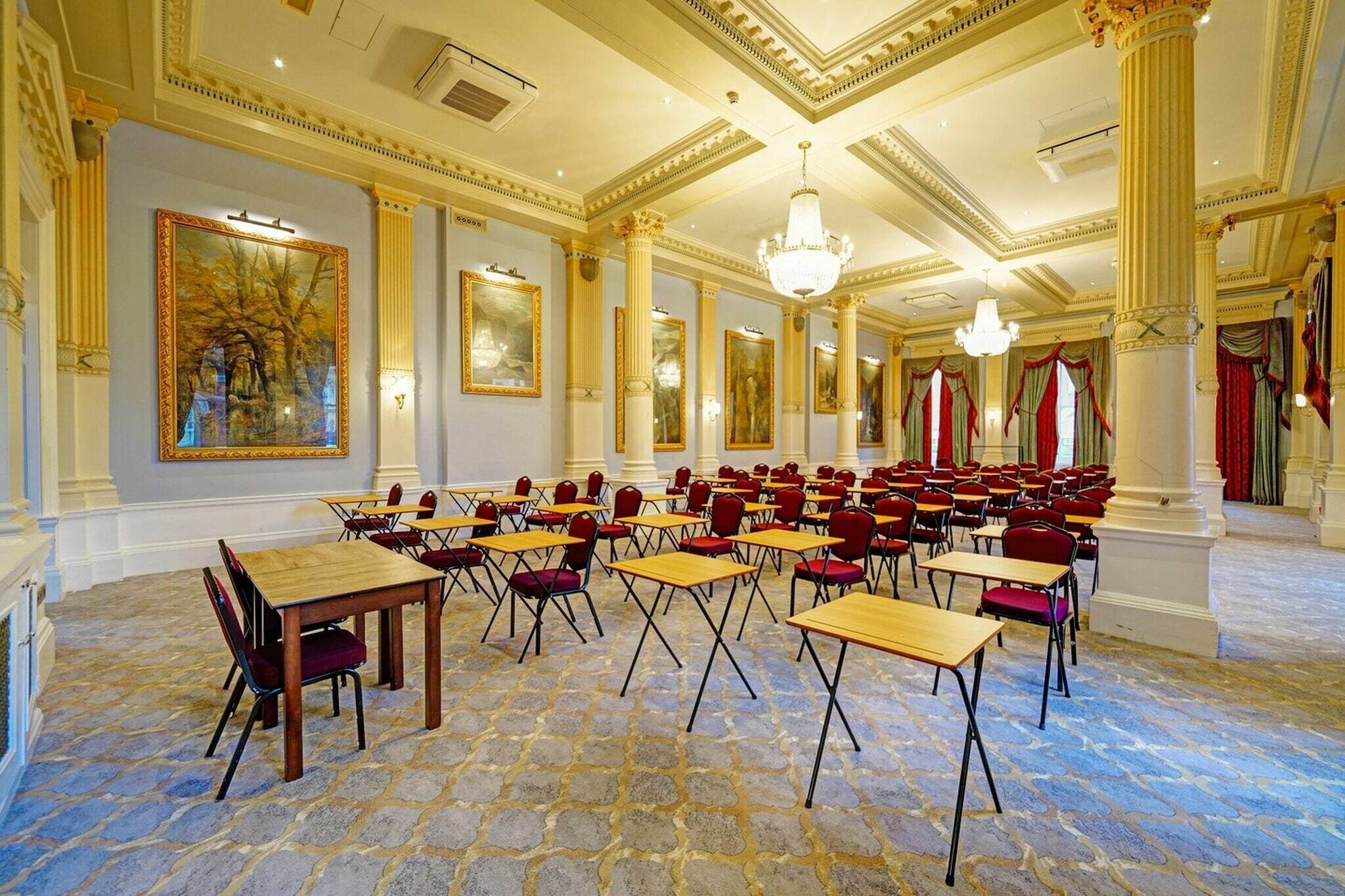 A large room with tables and chairs arranged for a meeting or event.