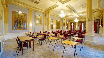 A large room with tables and chairs arranged for a meeting or event.