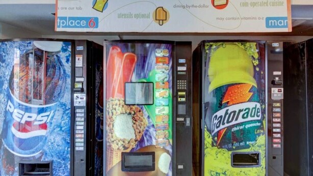 A row of beverage vending machines with Pepsi, a colorful drink, and Gatorade. - 2 Full Beds | Smoking (St George UT)