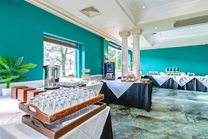 A banquet hall with tables set for a formal event, a coffee station, and a view of the outdoors. - Winchester Wessex Hotel by Sunday Double Room (Winchester)