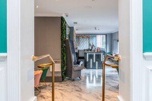 A modern interior with a staircase, a bar area, and seating. - Winchester Wessex Hotel by Sunday Double Room (Winchester)