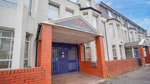 A building with a blue door and a sign reading 'OYO Cardiff Central'.