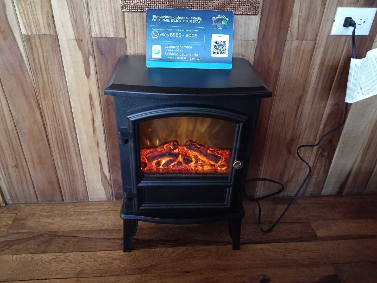 A wood-burning stove with a QR code and a welcome sign.
