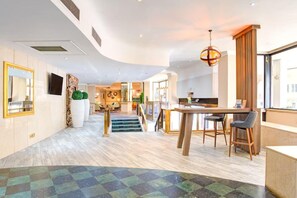 A hotel lobby with a staircase, a reception desk, and a dining area. - Atlantic Tower Hotel By Sunday - Classic Double room (Liverpool)