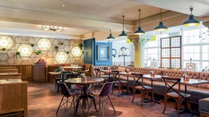A restaurant interior with hexagonal wall decor, wooden flooring, and a mix of seating arrangements including tables and benches. - Bristol Grand Hotel By Sunday - Deluxe Double Room (Bristol)