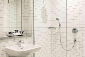 A bathroom with a white sink, a glass shower enclosure, and a mirror. - Bristol Grand Hotel By Sunday - Compact Double Room (Bristol)