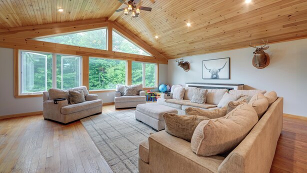 A spacious living room with a high ceiling, large windows, and a wooden floor. - Pet Friendly Family Getaway on 15 Acres! (Gouverneur)