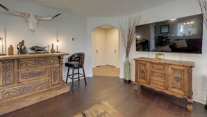 A room with a wooden bar, a large mirror, and a bull skull on the wall. - Private Yard & Deck! Group-Friendly Haven in Manor (Manor)