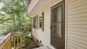 A house with a wooden deck, a door with a window, and a small window with shutters. - Modern Home Minutes to Mystic, Casinos and Ocean (Groton)
