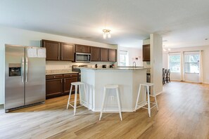 A modern kitchen with a central island, stainless steel appliances, and wooden cabinets. - Pool Table & Patio! Group Hub, 4 Mi to SeaWorld (San Antonio)