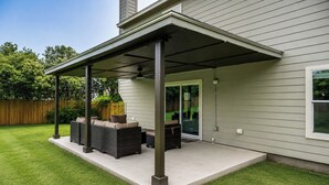 A covered patio with outdoor furniture, a ceiling fan, and a sliding glass door leading to a backyard. - Pool Table & Patio! Group Hub, 4 Mi to SeaWorld (San Antonio)